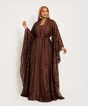 Amber two-piece brown lace dress set featuring a sleeveless pleated maxi inner dress, floral lace outer layer with fabric waist tie and flowing kimono silhouette - TORFEO