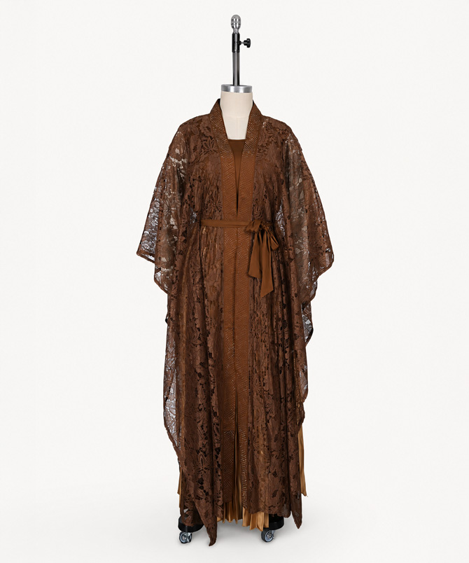 Amber two-piece brown lace dress set featuring a sleeveless pleated maxi inner dress, floral lace outer layer with fabric waist tie and flowing kimono silhouette - TORFEO