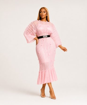 Roselle Bloom blush pink pleated midi dress featuring floral appliqués with gold tone studs, statement pleated sleeves, ruffle hem and black elastic waist belt with floral buckle - TORFEO